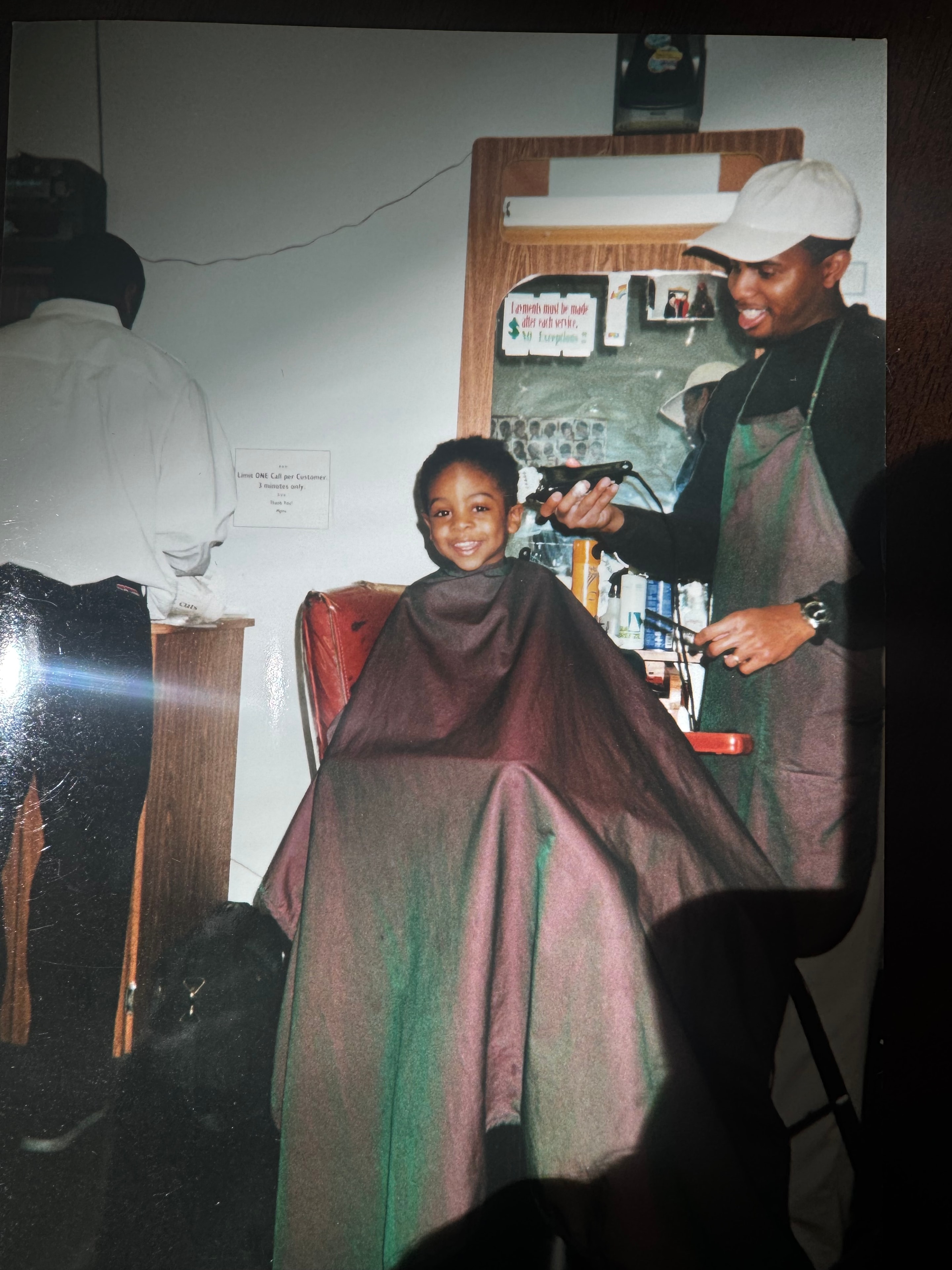 Young Anthony getting a haircut at the barbershop